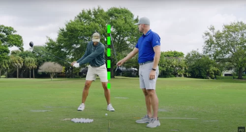 Pro golfer instructing how to get behind the ball