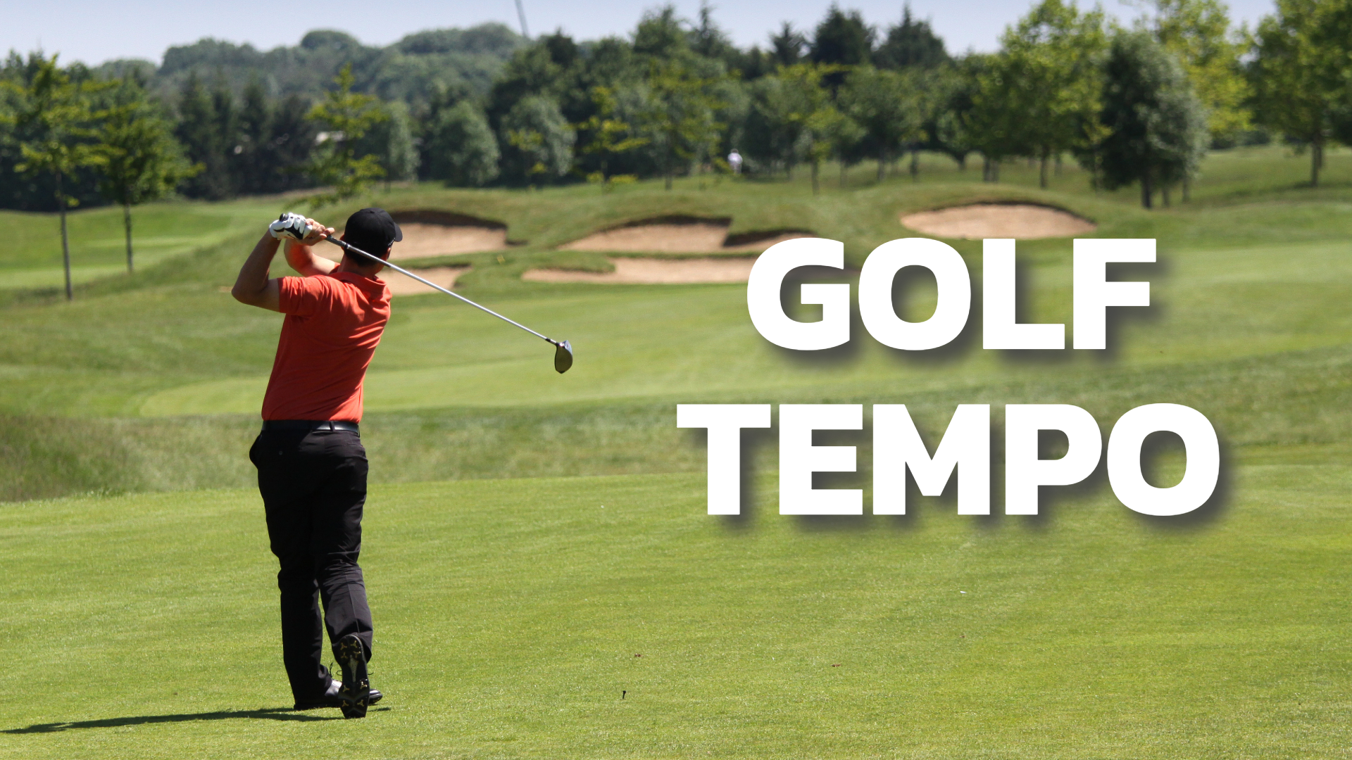 A shot from behind of a golfer wearing a red shirt on the golf course with bunkers and trees in the distance, with white text that reads “golf tempo” on the right of the image.