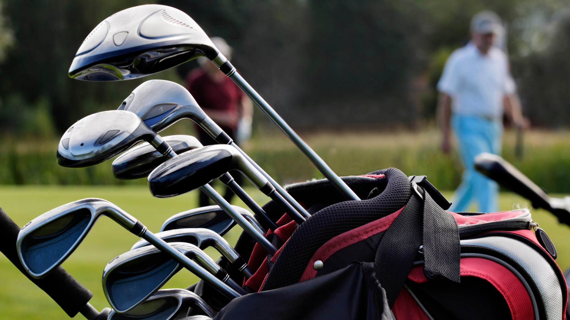 Close up shot of a golf bag with various golf clubs in it.