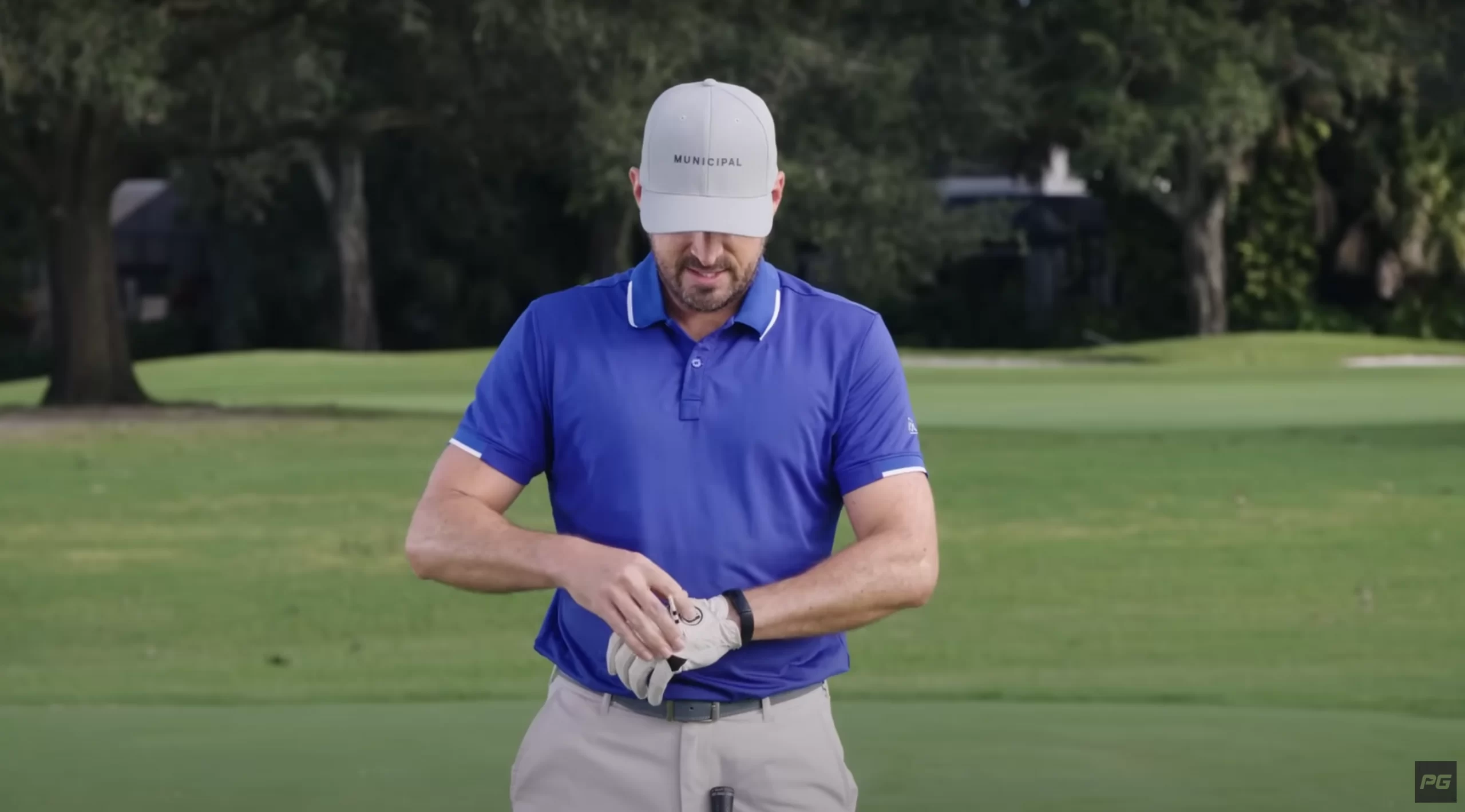 Performance Golf coach Eric Cogorno wrapping a golf tee on the top of his golf glove to use in a practice drill.