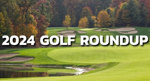 A golf course during the fall with autumn trees and various ponds and sand traps.