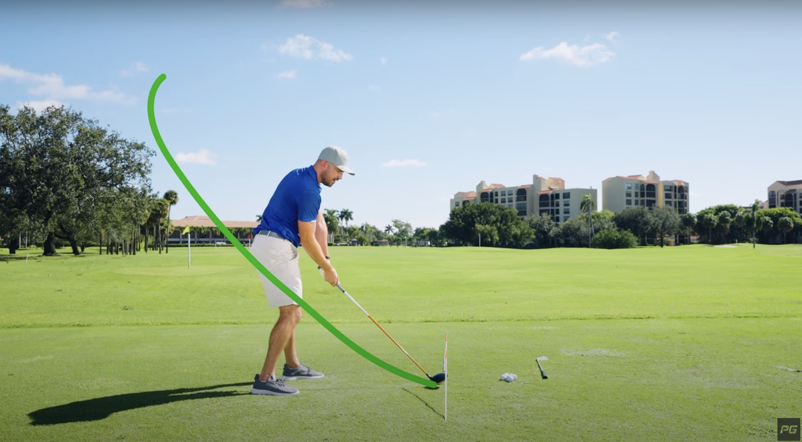 Performance Golf coach Eric Cogorno swinging a golf iron the proper way, using an alignment stick in a drill.