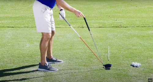 Performance Golf Coach Eric Cogorno showing the differences between the two golf clubs: an iron and a driver.